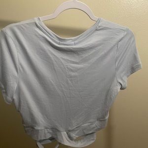 Mini cropped light blue shirt with cut outs . NEW - never worn . Tag still on